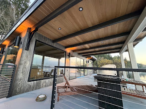Covered deck with a wood-look soffit and dark structural beams